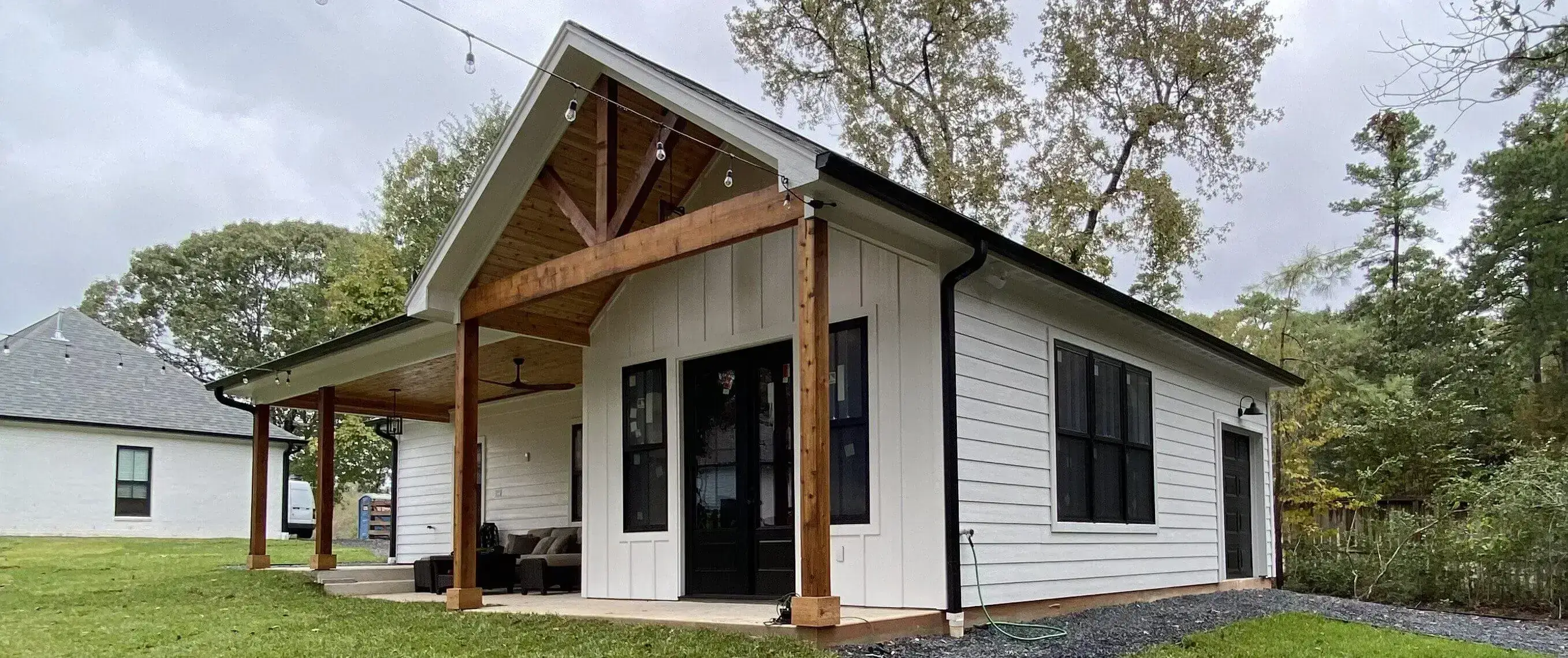 White cottage with exposed timber porch beams
