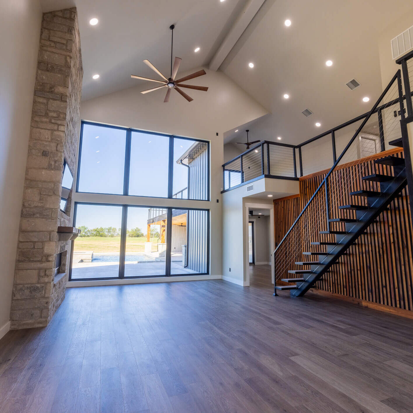 Spacious modern living room with high ceilings and large windows.